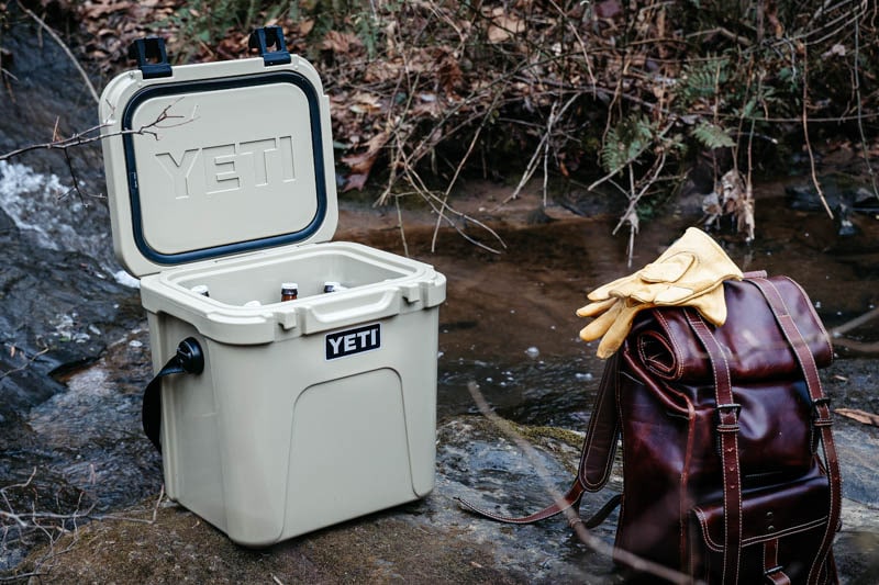 yeti roadie 24 on river with leather bag