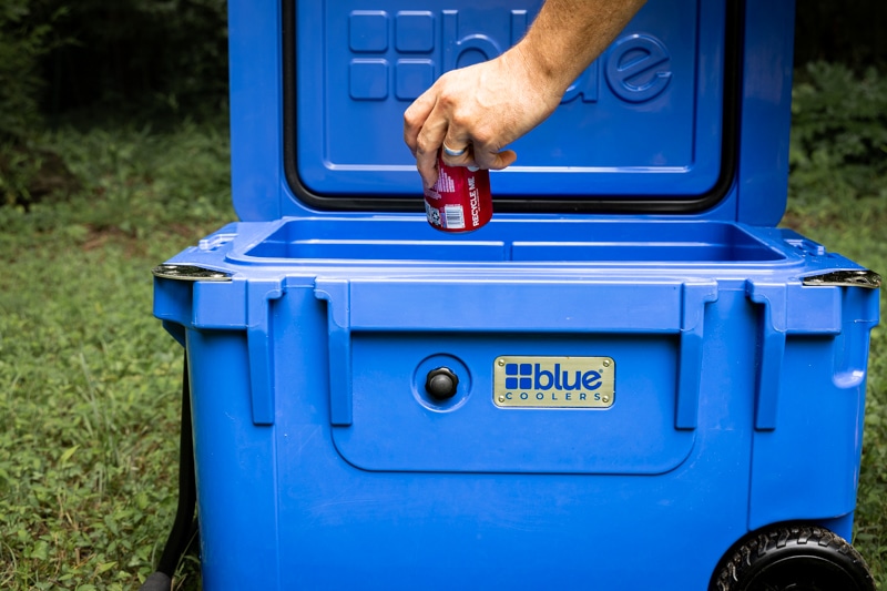 grabbing a drink from blue coolers