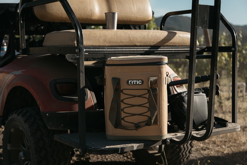 RTIC backpack cooler on the back cage of golf cart