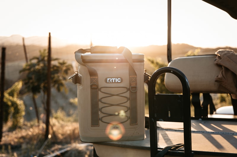 RTIC backpack cooler with sun glistening in background