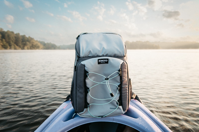 https://coolerspy.com/wp-content/uploads/2022/10/Igloo-backpack-cooler-on-kayak-in-lake.jpg